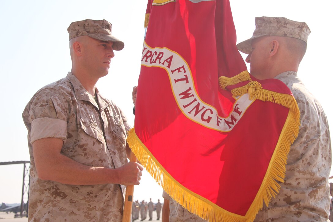 Outgoing Marine Attack Squadron 223 commanding officer Lt. Col. John K. Adams, right, passes the colors to incoming commanding officer Lt. Col. Thomas D. Gore during the VMA-223 change of command ceremony at the squadron’s hangar, Oct 13.
