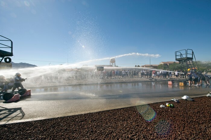 NELLIS AIR FORCE BASE, Nev.-- The final event of the 2010 Fire Muster competition was a water hose tag-a-war.  A metal barrel was suspended on a cable as two opposing teams tried to move it to the opposite end using a high pressurized fire hose. The Nellis Fire Department hosted the 4th annual Fire Muster competition on Oct 8. (U.S. Air Force photo by Lawrence Crespo) 


 