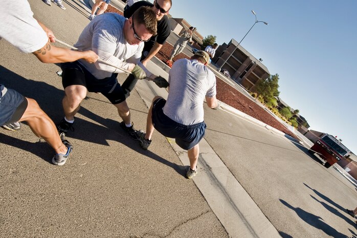 NELLIS AIR FORCE BASE, Nev.-- All fourteen teams participating in the 4th annual Fire Muster pulled a P-19 Aircraft Rescue Firefighting vehicle during the competition at the Nellis Sport Pavilion Oct. 8. The P-19 is a highly mobile, self-sufficient firefighting vehicle. It has a diesel engine, with 4X4 all wheel drive chassis designed to fight fires over any terrain, and be compact enough to serve as a mobile firefighting vehicle, able to be loaded on most cargo aircraft and deployed anywhere in the world. (U.S. Air Force photo by Lawrence Crespo) 


 