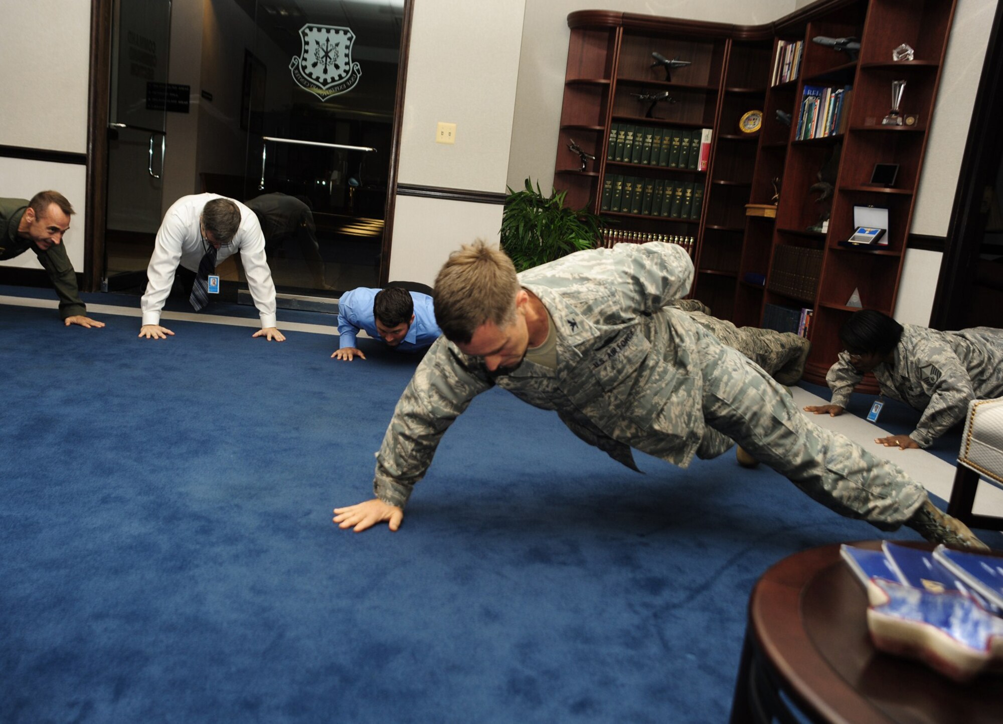 Col. Mark Ellis, the Expeditionary Operations School commandant at the U.S. Air Force Expeditionary Center at Joint Base McGuire-Dix-Lakehurst, N.J., performs push-ups Oct. 9, 2010, in the command section during the center’s Ground Up Fitness Challenge. Students and faculty at the center perform sets of push-ups and sit-ups at designated times each day as part of the organization's overall effort to instill a commitment to fitness. (U.S. Air Force photo/Staff Sgt. Zachary Wilson)