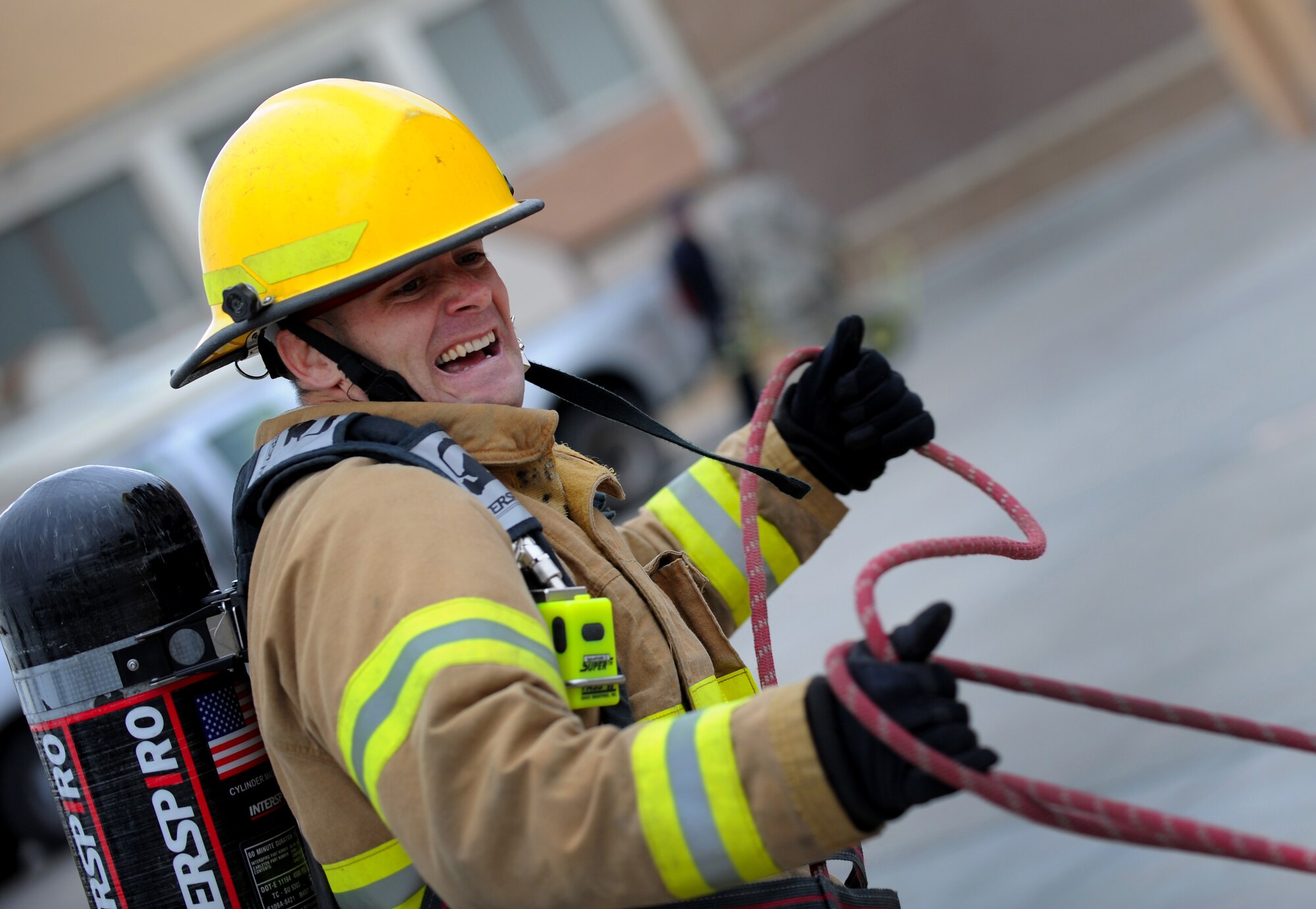 MOUNTAIN HOME AFB, Idaho -- Capt. Keith Quick, 366th Security Forces Squadron commander, pulls a 5-inch hose 100 feet during the fire muster challenge here Oct. 8. The challenge helps Airmen receive a better understanding of the effort it takes to rescue and protect individuals involved in fires. (U.S. Air Force photo by Staff Sgt. Gina Chiaverotti-Paige)