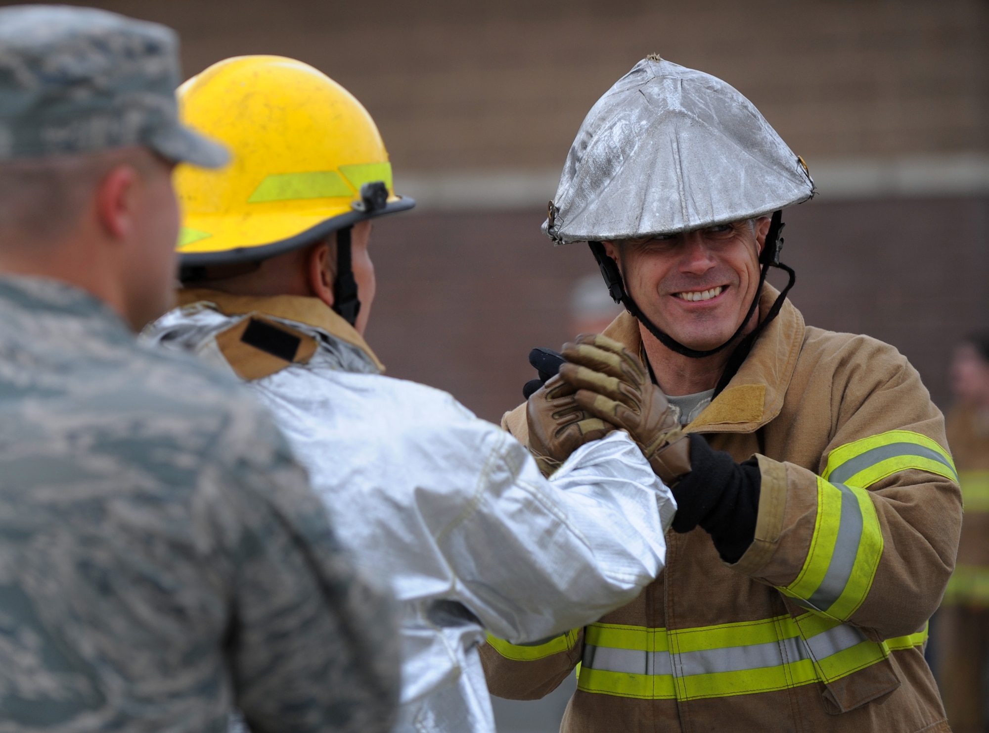 MOUNTAIN HOME AFB, Idaho -- Chief Master Sgt. Michael Veros, 366th Security Forces Squadron chief, is congratulated after his performance in the fire muster challenge here Oct. 8. Sergeant Veros’ team consisted of chiefs and commanders from the Civil Engineer Squadron and Security Forces Squadron. (U.S. Air Force photo by Staff Sgt. Gina Chiaverotti-Paige)