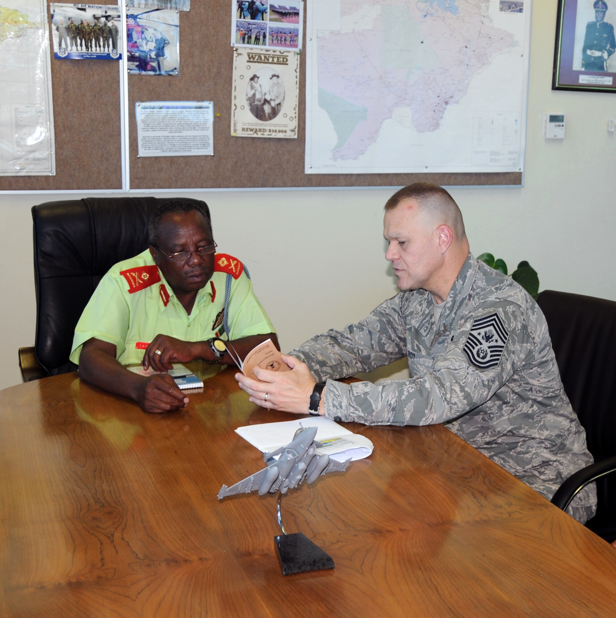 Chief Master Sgt. of the Air Force James A. Roy discusses the enlisted force structure with Botswana Defense Force Air Arm Command Maj. Gen. T.M. Paledi Oct. 11, 2010, during a visit to Thebaphatshwa Air Base, Botswana. Chief Roy and a team from 17th Air Force spent the day discussing enlisted force development members of with the BDF. (U.S. Air Force photo/Master Sgt. Jim Fisher)