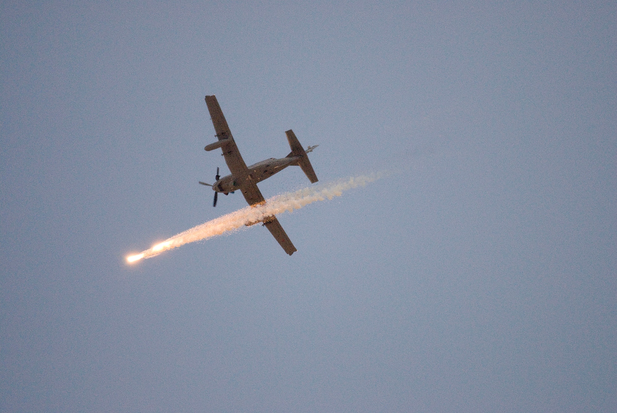 A Hawker Beechcraft AT-6C, modified for various light attack missions, releases flares during an operational test over the Southern Arizona desert Oct. 5. It was the first time flare buckets, or aircraft survivability equipment, were mounted onto the airplane and fully integrated with the control system on board. A team of pilots and engineers certified that the airplane could separate the flares correctly while learning if the modification would have adverse effects on the airplane’s handling. The Air National Guard, Air Force Reserve Command Test Center based in Tucson, Ariz., is working with various defense contractors and pilots from across the Air Force this month to evaluate the aircraft’s suitability for an array of missions. (Air Force photo by Master Sgt. Dave Neve)