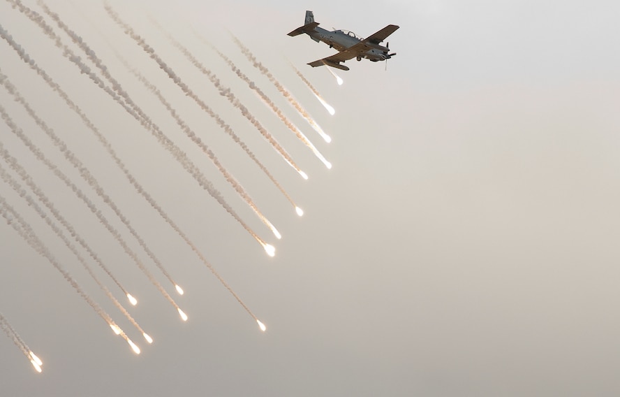 A Hawker Beechcraft AT-6C, modified for various light attack missions, releases flares during an operational test over the Southern Arizona desert Oct. 5. It was the first time flare buckets, or aircraft survivability equipment, were mounted onto the airplane and fully integrated with the control system on board. A team of pilots and engineers certified that the airplane could separate the flares correctly while learning if the modification would have adverse effects on the airplane’s handling. The Air National Guard, Air Force Reserve Command Test Center based in Tucson, Ariz., is working with various defense contractors and pilots from across the Air Force this month to evaluate the aircraft’s suitability for an array of missions. (Air Force photo by Master Sgt. Dave Neve)