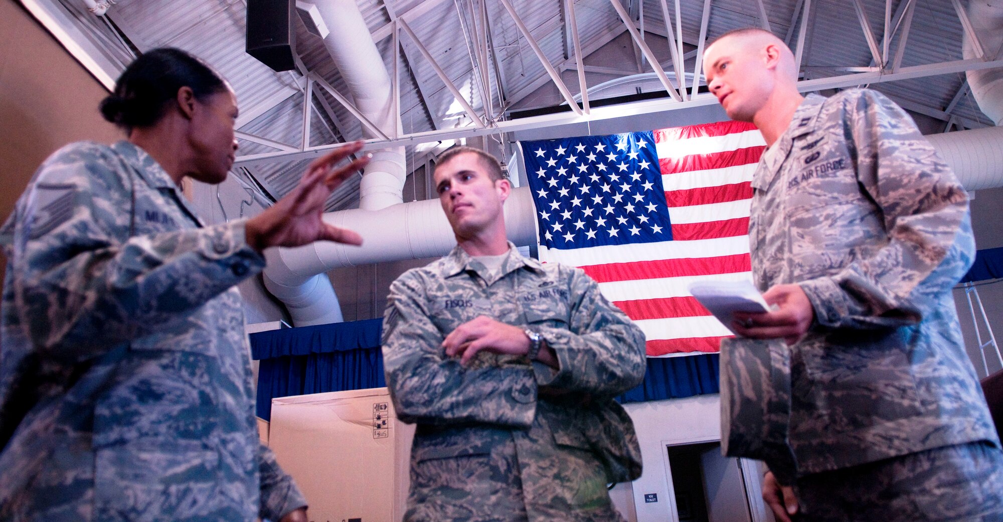 Master Sgt. Kimberly Muhlecke discusses standup items with Master Sgt. Matthew Fiscus, the Guard's First Sergeant and Capt. Justin Hochstein of the Ceremonial Guard. Sergeant Muhlecke recently earned the Katherine Wright award from the National Aeronautical Association for her work advancing the science and art of flight. 