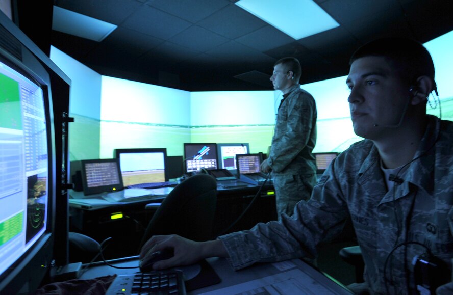 101006-F-4406D-023 SHAW AIR FORCE BASE, S.C.--    Airman 1st Class Dallon Gines, 20th Operational Support Squadron air traffic controller, trains Airman 1st Class Christopher Cochran, 20th OSS air traffic controller apprentice on the tower simulator Oct. 7, 2010.  The TSS trains air traffic controller apprentices for live traffic.  This is just one of the many training tools air traffic controllers use to stay up to par with their training requirements. (U.S. Air Force photo/ Airman 1st Class Tabatha L. Duarte(Released)
