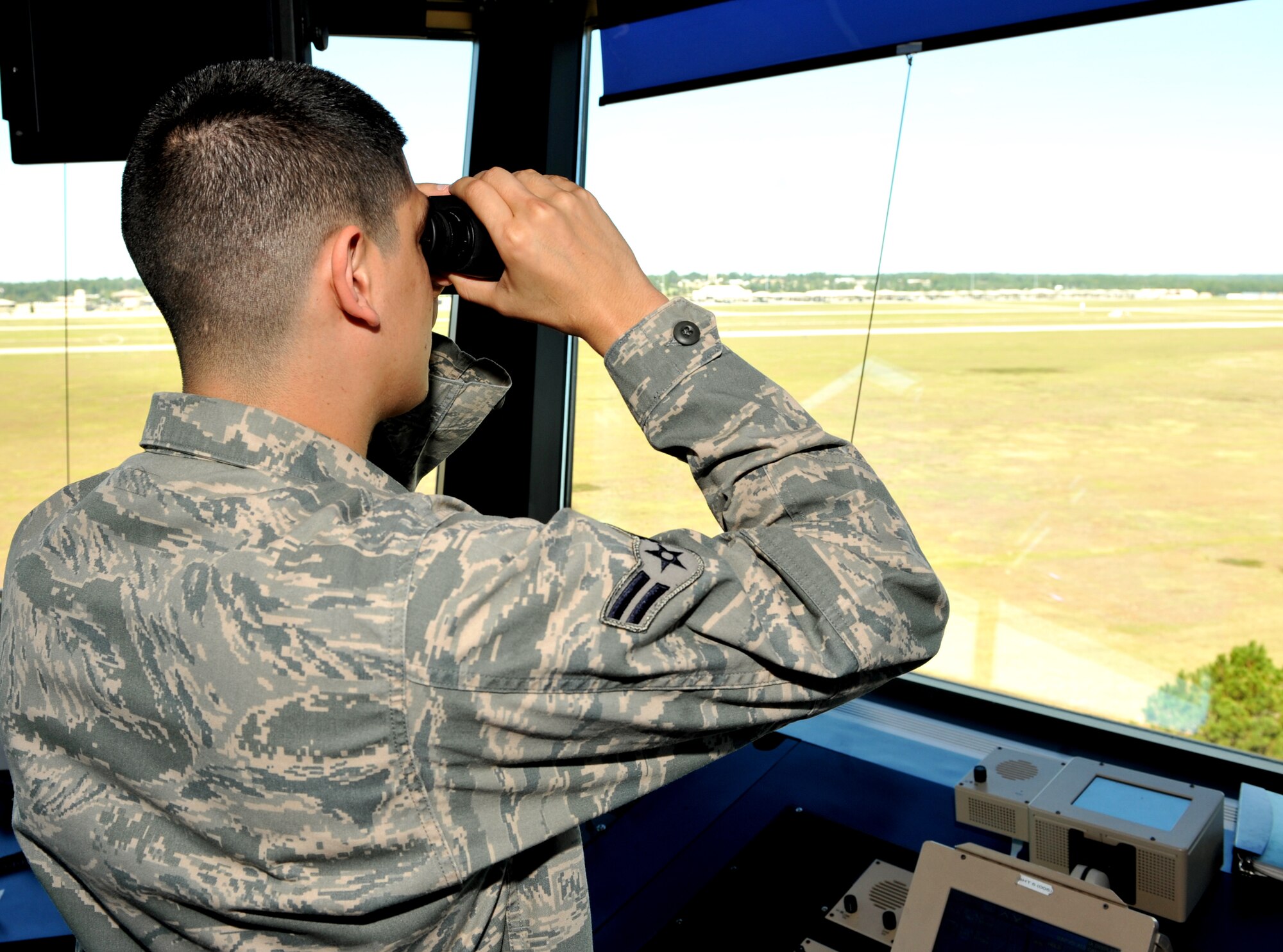 101006-F-4406D-006 SHAW AIR FORCE BASE, S.C.--    Airman 1st Class Dallon Gines, 20th Operational Support Squadron air traffic controller, searches the flightline for flocks of birds that may impact F-16's landing or taking off, Oct. 7, 2010, Shaw Air Force Base, S.C. Air traffic controllers insure the airfield stays safe for departing and landing aircraft. (U.S. Air Force photo/ Airman 1st Class Tabatha L. Duarte(Released)