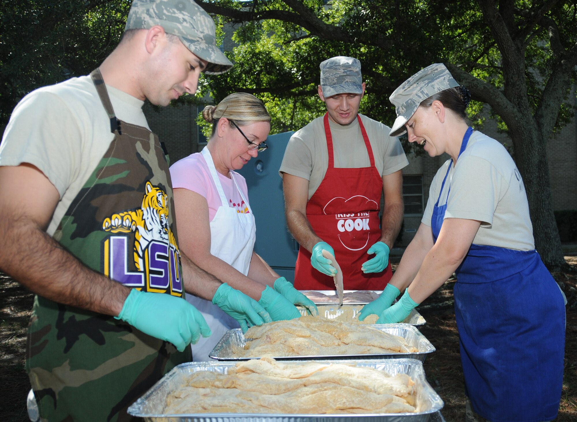 Staff Sgt. Kyle Grantham,Master Sgt. Darlene Santana, Airman 1st Class Kris Holt and
Tech. Sgt. Tammy Pfeifer, 81st Diagnostics and Therapeutics Squadron, prepare fish to be fried.  (U.S. Air Force photo by Kemberly Groue)