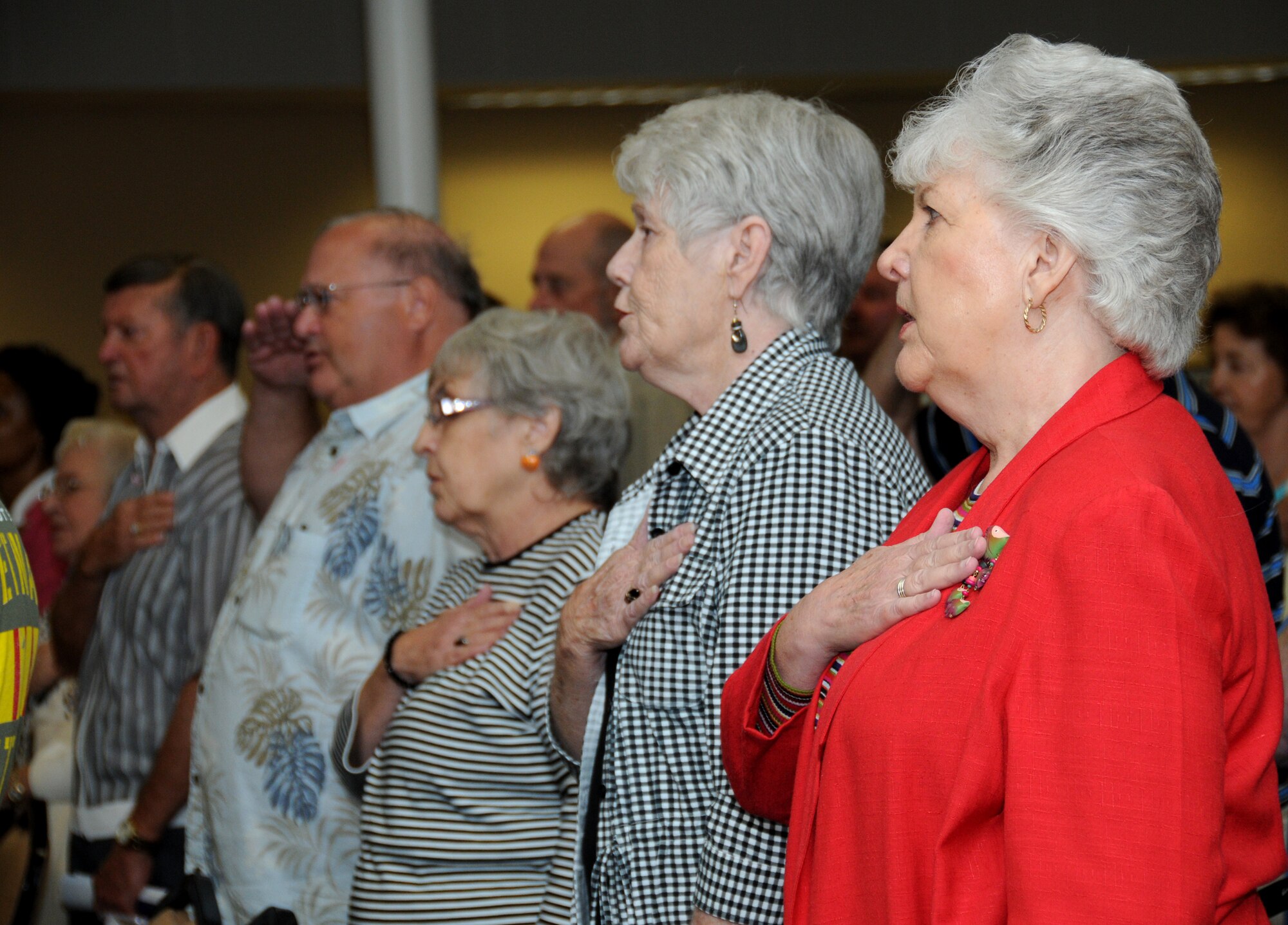 AnitaMcAllister, left, and Lula Barberee of Ocean Springs join in the Pledge of Allegiance. Mrs. McAllister is married to retired Senior Master Sgt. Ivan McAllister. Mrs. Barberee’s late husband, Austin, was a retired master sergeant.  (U.S. Air Force photo by Kemberly Groue)