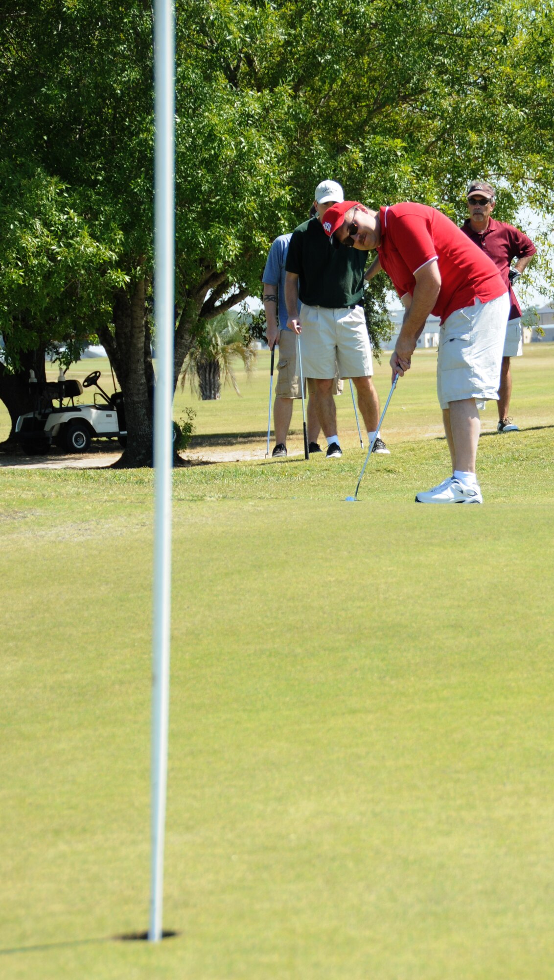 Rand Bundenthal putts on the green on Hole 9 at Bay Breeze Golf Course during Friday’s Wounded Warrior Golf Tournament. Bundenthal and his teammates from the 81st Training Support Squadron — Thomas Sirovey, Robert Walker and David Carley — won the event. Daniel Ransom, 81st Medical Group recovery care  coordinator, said that this year’s tournament raised $700 for wounded, injured or ill service members through the local Disabled American Veterans organization.   (U.S. Air Force photo by Kemberly Groue)