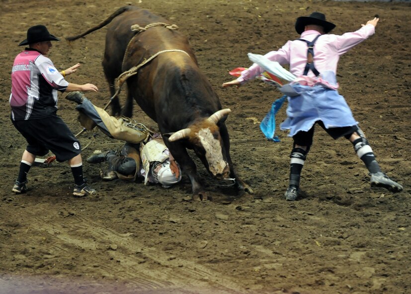 MINOT, N.D. -- Clay Hindman of Belvidere, S.D., finds out what the dark side of bull riding can be as he gets run over during the 2010 Y’s Men’s Rodeo here Oct. 8. The 56th annual Y’s Men’s Rodeo was held at the North Dakota State Fairgrounds Oct. 7 to 10 with all proceeds from the rodeo benefiting the YMCA’s Triangle Y Camp located near Garrison, N.D. (U.S. Air Force photo by Staff Sgt. Keith Ballard)
