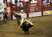 MINOT, N.D. -- Clay Hindman of Belvidere, S.D., attempts to ride a bull that has never been ridden during the bull riding portion of the 2010 Y’s Men’s Rodeo here Oct. 8. The 56th annual Y’s Men’s Rodeo was held at the North Dakota State Fairgrounds Oct. 7 to 10 with all proceeds from the rodeo benefiting the YMCA’s Triangle Y Camp located near Garrison, N.D. (U.S. Air Force photo by Staff Sgt. Keith Ballard)
