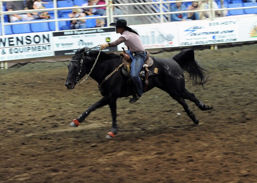 MINOT, N.D. – Brittany Fleck of Mandan, N.D., races for the start/finish line during the barrel racing segment at the 2010 Y’s Men’s Rodeo here Oct. 8. The 56th annual Y’s Men’s Rodeo was held at the North Dakota State Fairgrounds Oct. 7 to 10 with all proceeds from the rodeo benefiting the YMCA’s Triangle Y Camp located near Garrison, N.D. (U.S. Air Force photo by Staff Sgt. Keith Ballard)