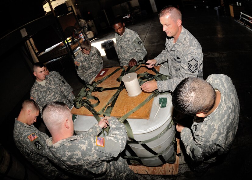 Master Sgt. Todd Russell of the 914th Airlift Wing trains soldiers from the U.S. Army 10th Mountain Division, Fort Drum NY, the proper way to rig a pallet for a drop from a C-130 October 13, 2010, Niagara Falls Air Reserve Station, Niagara Falls NY. This joint exercise was conducted by members of the 914th Airlift Wing, 107th Airlift Wing and the U.S. Army 10th Mountain Division (U.S. Air Force photo by Staff Sgt. Joseph McKee)