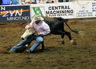MINOT, N.D. – Jim Hansen of Watford City, N.D., digs in his boots before wrestling a steer to the ground during the 2010 Y’s Men’s Rodeo here Oct. 8. The 56th annual Y’s Men’s Rodeo was held at the North Dakota State Fairgrounds Oct. 7 to 10 with all proceeds from the rodeo benefiting the YMCA’s Triangle Y Camp located near Garrison, N.D. (U.S. Air Force photo by Staff Sgt. Keith Ballard)