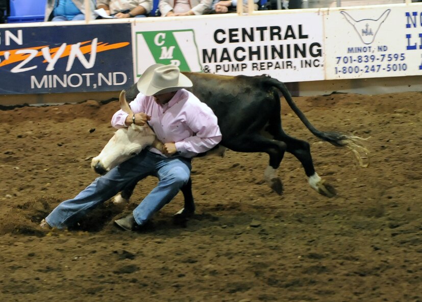 MINOT, N.D. – Jim Hansen of Watford City, N.D., digs in his boots before wrestling a steer to the ground during the 2010 Y’s Men’s Rodeo here Oct. 8. The 56th annual Y’s Men’s Rodeo was held at the North Dakota State Fairgrounds Oct. 7 to 10 with all proceeds from the rodeo benefiting the YMCA’s Triangle Y Camp located near Garrison, N.D. (U.S. Air Force photo by Staff Sgt. Keith Ballard)