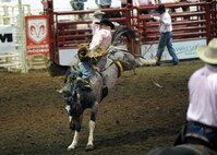 MINOT, N.D. -- Weston Garrett of Belle Fourche, S.D., competes in the bareback bronc competition during the 2010 Y’s Men’s Rodeo here Oct. 8. The 56th annual Y’s Men’s Rodeo was held at the North Dakota State Fairgrounds Oct. 7 to 10 with all proceeds from the rodeo benefiting the YMCA’s Triangle Y Camp located near Garrison, N.D. (U.S. Air Force photo by Staff Sgt. Keith Ballard)