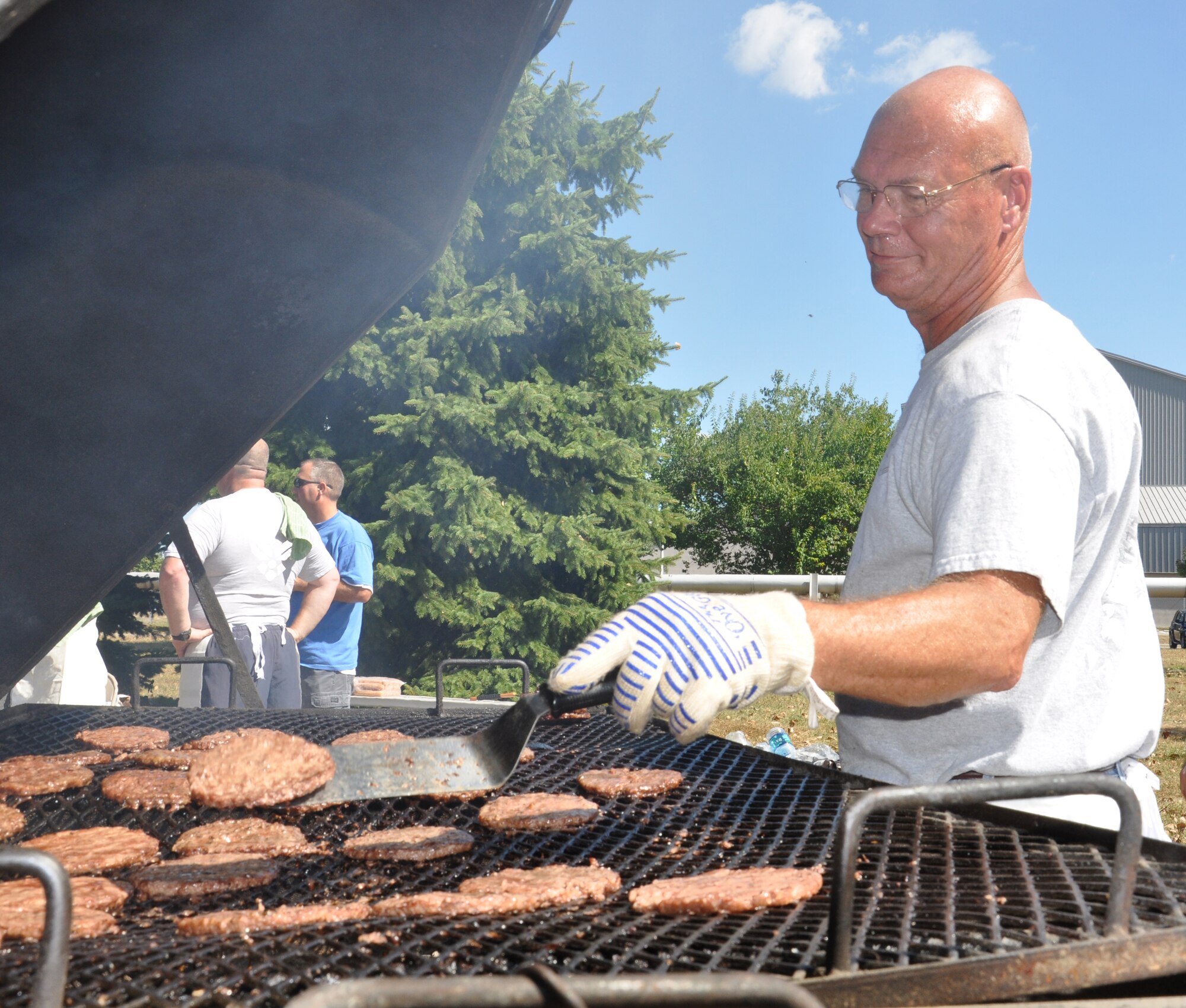 WRIGHT-PATTERSON AIR FORCE BASE, Ohio - Master Sgt. Jude Soriano, 445th Maintenance Squadron, grills hamburgers and hot dogs during the 445th Airlift Wing picnic Sept. 12. (U.S. Air Force photo/Senior Airman Mikhail Berlin)