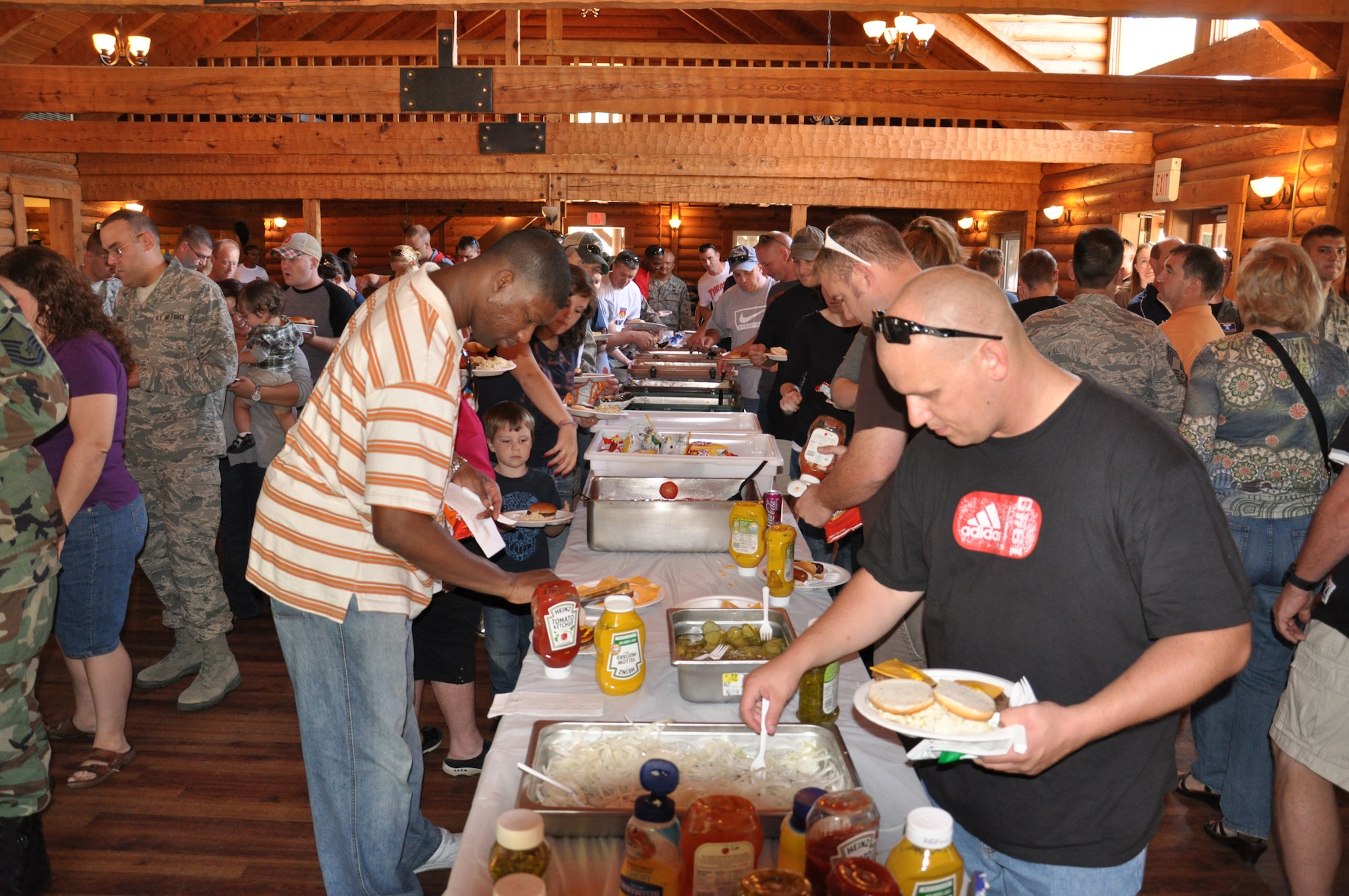 WRIGHT-PATTERSON AIR FORCE BASE, Ohio - Airmen and families move down the food line at the 445th Airlift Wing picnic Sept. 12.  Hamburgers, hot dogs, pasta salad and baked beans were served, along with chips and an assortment of desserts and drinks. (U.S. Air Force photo/Senior Airman Mikhail Berlin)