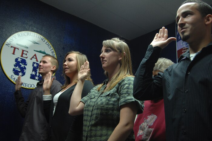 NELLIS AIR FORCE BASE, Nev. – Navy enlistment candidates take the oath of enlistment as part of the new Satellite Outlying Area Processing Station commencement. The SOAP station opened during a ceremony Oct. 7 and is first-ever processing center for recruits of the U.S. military in state of Nevada.