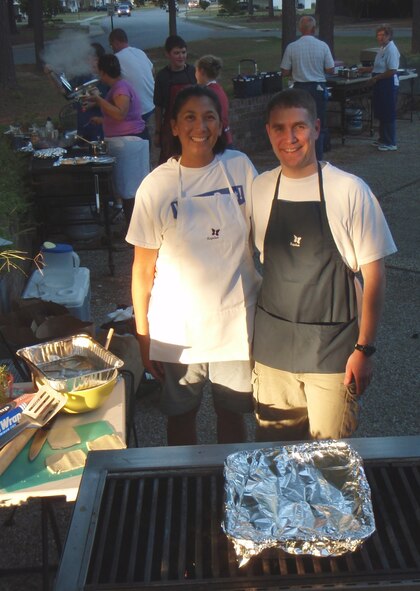 Capt. Ann-Kristine H. Thrift and husband Capt. Matthew B. Thrift  enjoy the Iron Chef competition on base on Sept. 10, 2010. The Thrifts won the competition with their creative and tasteful dishes. (USAF photo courtesy of 916th OSS)