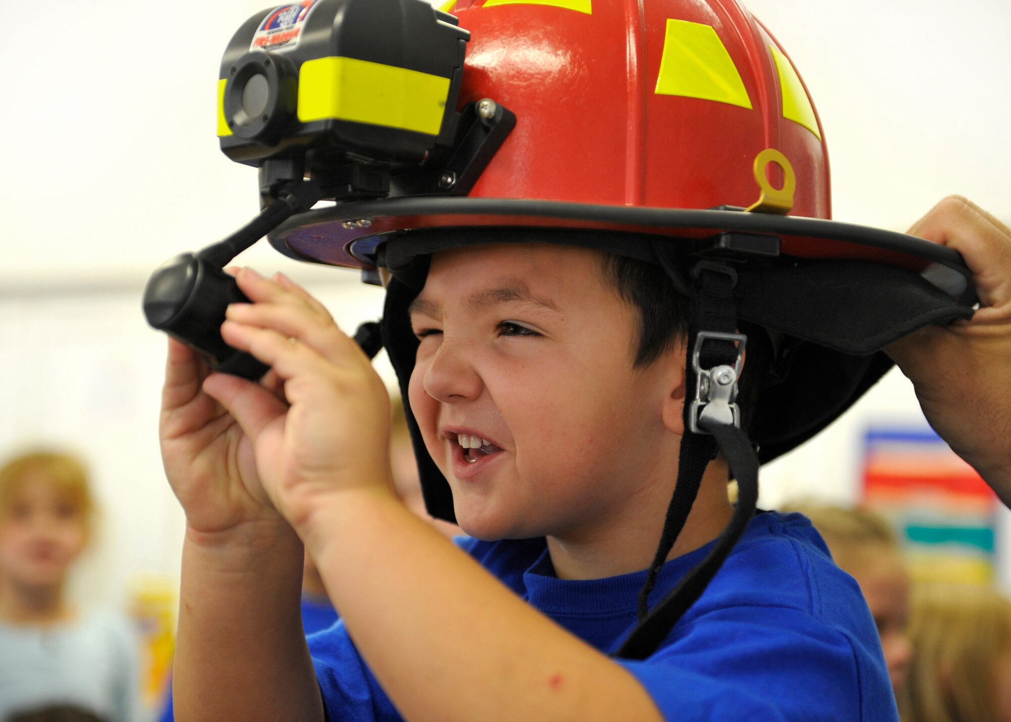 HOLLOMAN AIR FORCE BASE, N.M. -- Justin Hunter, son of Misty Hunter, 3rd grade teacher at Holloman Elementary School, looks through the thermal imagers of a fireman's hat during this year's Fire Prevention Week Oct. 9, 2010. Members of the 49th Civil Engineer Squadron's Fire Department conducted fire equipment demonstrations and performed fire evacuation drills throughout the week to promote fire safety awareness. (U.S. Air Force photo by Senior Airman Veronica Stamps / Released)
