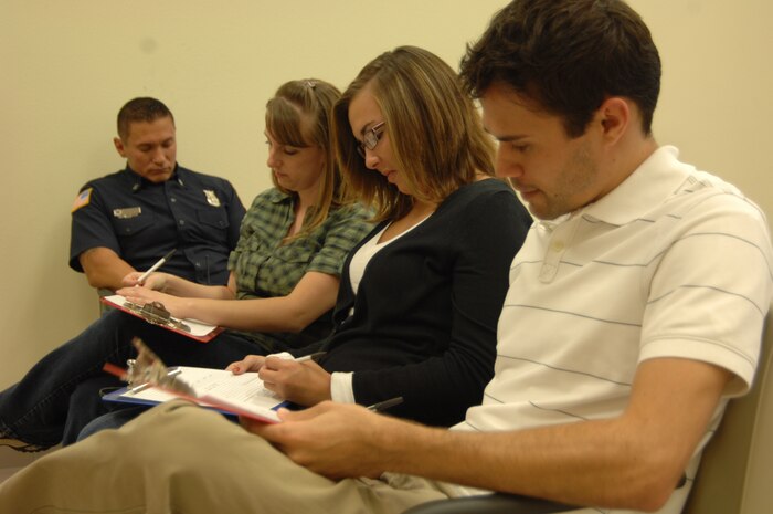 NELLIS AIR FORCE BASE, Nev. – Navy enlistment candidates fill out their medical paperwork at the 99th Flight Medicine Squadron here, as part of the new Satellite Outlying Area Processing Station commencement. The SOAP station opened during a ceremony Oct. 7 is the first-ever processing center for recruits of the U.S. military in state of Nevada.