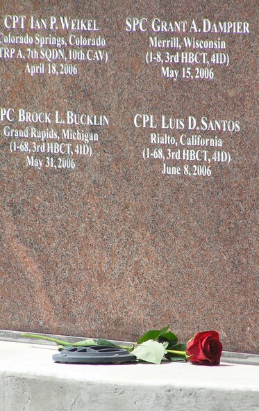A single rose placed by family members lies before a section of the Pikes Peak Region Memorial Wall Aug. 22 during a dedication ceremony in Cripple Creek, Colo. Members of the U.S. Armed Forces who have been killed in action since Sept. 11, 2001 and were stationed at one of the local five area installations, had a home of record in El Paso or Teller County or were U.S. Air Force Academy graduates are listed on the wall. From June 2009 to May 2010, 54 servicemembers who lost their lives in combat and were added to the wall. The memorial wall, which now has a total of 331 names displayed, is located at Cripple Creek's Mt. Pisgah Cemetery. (U.S. Air Force photo/Ann Skarban)