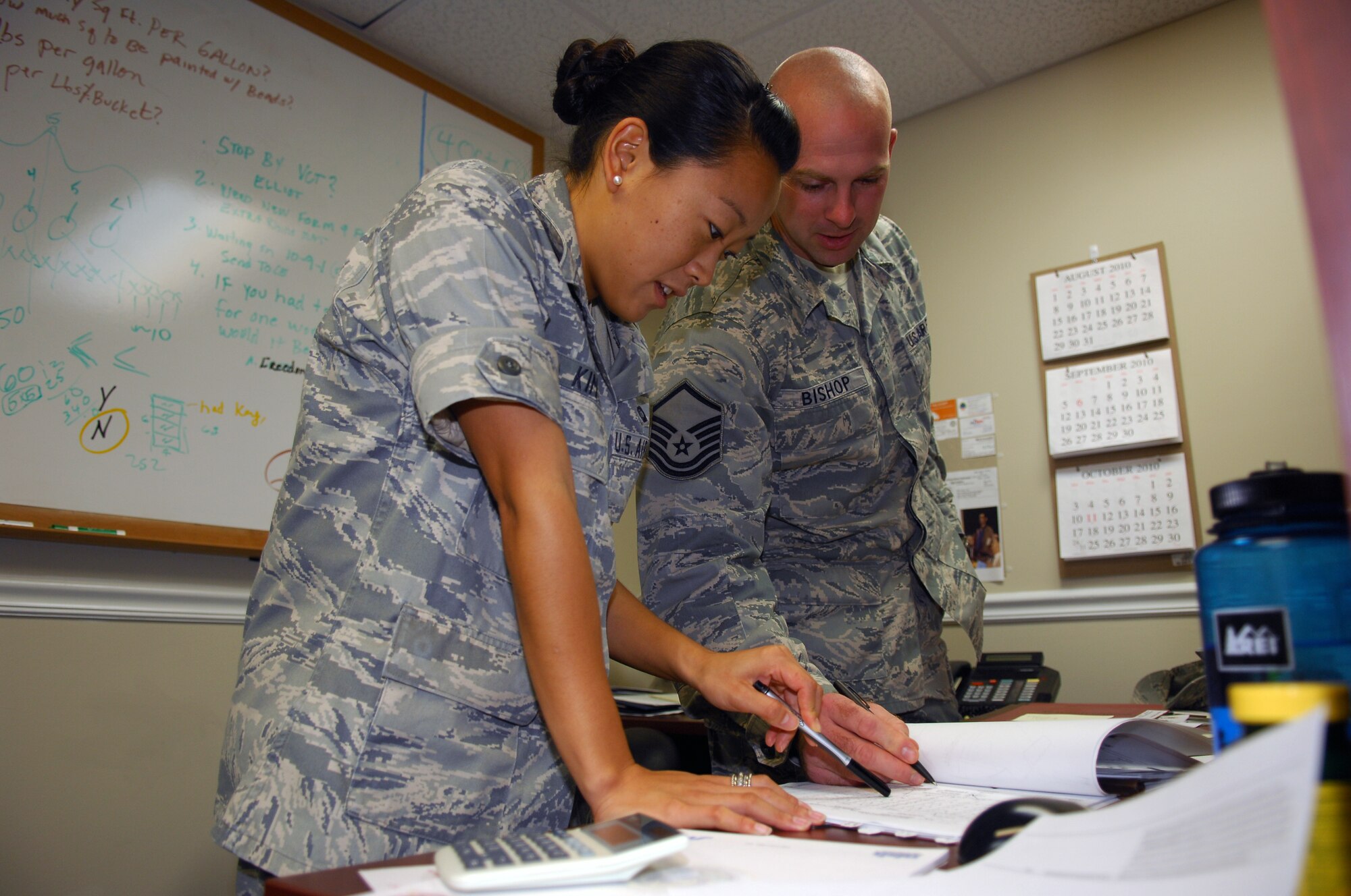 1st Lt. Ester Kim and Master Sgt. Eric Bishop, 43rd Contracting Squadron Contracting Managers, review information provided in a recent contract Sept. 30. The 43rd Comptroller and 43rd CONS Squadrons worked late into the night Sept. 30 to complete the 2010 Fiscal Year Closeout. (U.S. Air Force photo/Senior Airman Kris Levasseur)