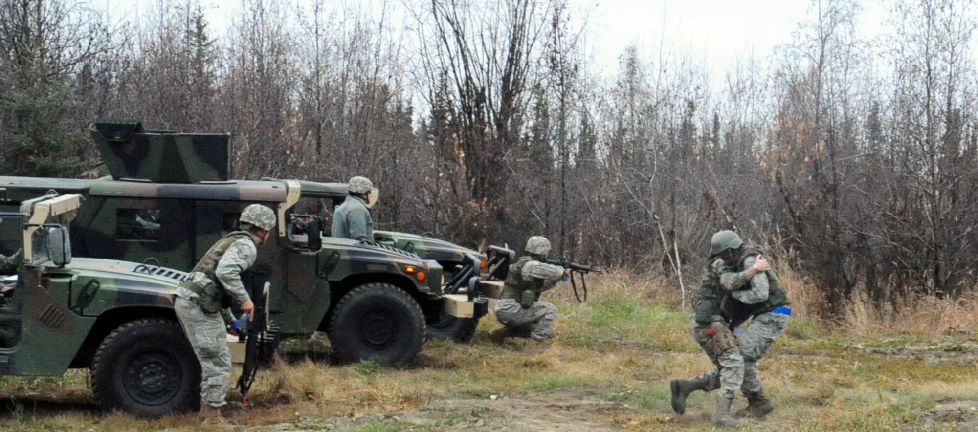 Airmen rush to rescue comrades during a preparedness exercise Oct. 7, 2010 Eielson Air Force Base, Alaska. The 354th Civil Engineering Squadron Explosive Disposal Flight familiarized Airmen with fundamentals of weapons safety, small tactical troop movements, combat life saver skills, and improvised explosive devices for deploying Airmen. The Airmen are assigned to the 354th CES. (U.S. Air Force photo/Airman 1st Class Laura Goodgame)
