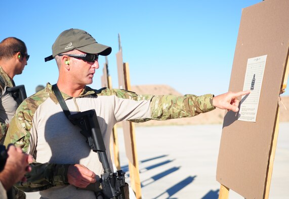 DAVIS-MONTHAN AIR FORCE BASE, Ariz. - Deployed from Patrick Air Force Base, Fla. to the Arizona desert, Master Sgt. Chris Seinkner, an Air Force Reserve pararescuemen or PJ, checks his target after participating in a shooting competition which is part of a pararescue rodeo - a week-long training event Oct. 4-10, 2010, that pitted seven active duty and Reserve pararescue teams against each other. The competitive events include areas of specialty which PJs must practice to become proficient rescue specialists. They included: shooting, free-fall parachuting, combat movements, medical and navigation. The Reserve PJs from Patrick's 920th Rescue Wing, the only Reserve Rescue Wing in the nation, placed third out of seven teams. (U.S. Air Force photo/ Airman First Class Jerilyn Quintanilla) 
