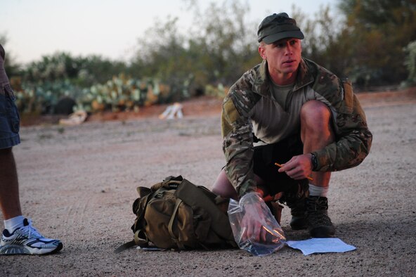 DAVIS-MONTHAN AIR FORCE BASE, Ariz. - Air Force Reservist Master Sgt. John Grant, deployed from Patrick Air Force Base's 920th Rescue Wing, listens to instructions before plotting a course for the navigation portion of the pararescue rodeo - a week-long training event that pitted seven active duty and Reserve PJ teams against each other in events they must be proficient at when they perform life-saving missions. The events included: shooting, free-fall parachuting, combat movements, medical and navigation. The Reservists Florida, the only Reserve PJs in the nation, placed third out of seven teams. (U.S. Air Force photo/Airman First Class Jerilyn Quintanilla) 