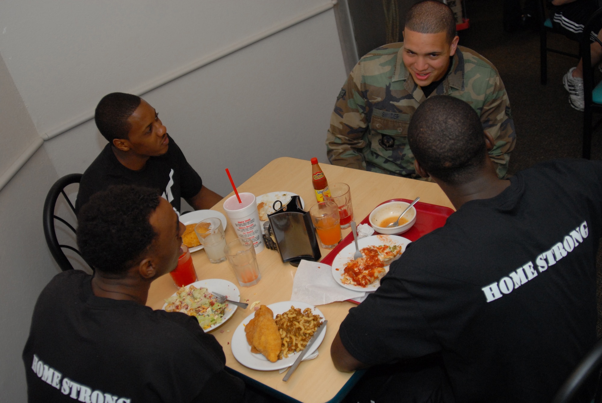 U. S. Air Force Senior Airman George Snyder, 1st Special Operations Aircraft Maintenance Squadron, talks with Miami HEAT players during a surprise lunch visit at the Reef Dining Facility, Hurlburt Field, Fla., Sept. 30, 2010. The HEAT players and staff took time from their 2010 Training Camp to meet with Airmen and learn the missions of Hurlburt Field and Eglin Air Force Base. (DoD photo by U. S. Air Force Staff Sgt. Orly N. Tyrell/Released) 