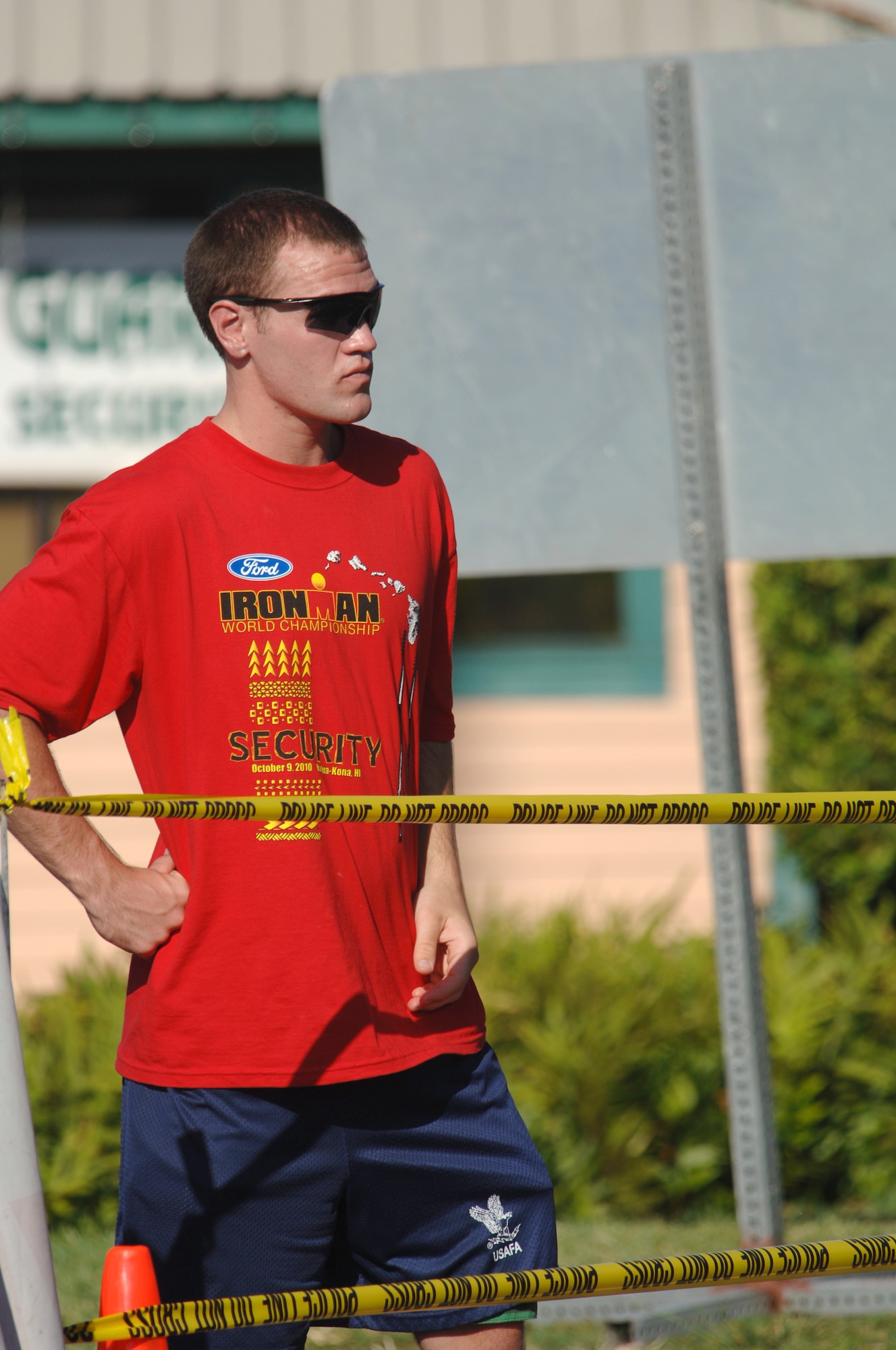 Cadet 3rd Class Neil Corran provides security for the Ironman Triathlon in Kailua-Kona, Hawaii, Oct. 9, 2010. Cadet Corran was one of 36 members of Cadet Squadron 04 who volunteered for the event as the squadron's Fall 2010 Cadet Service Learning project. (U.S. Air Force photo/Staff Sgt. Raymond Hoy)