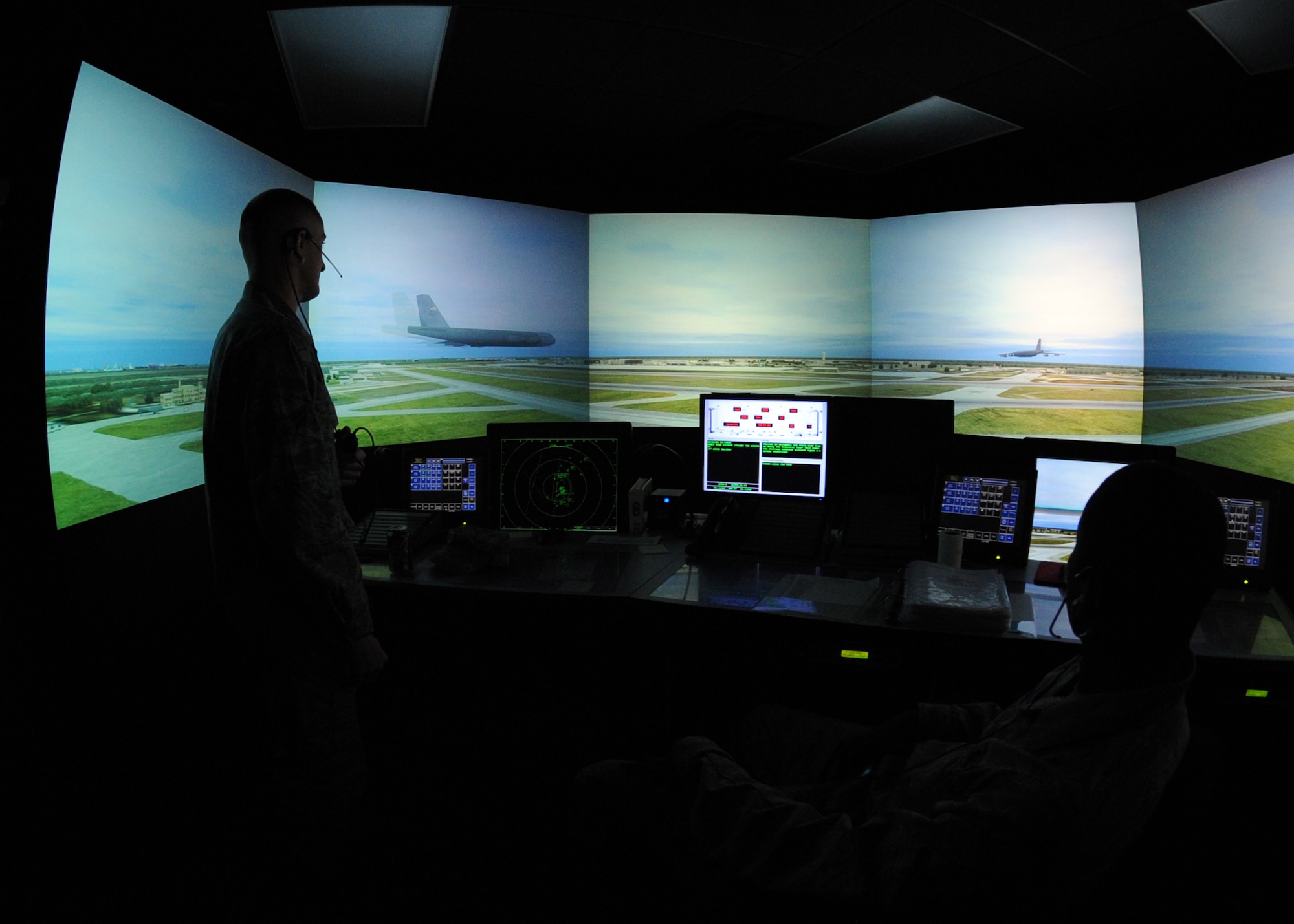 Airman 1st Class Josh Neal and Airman Eric Emmanuel, 22nd Operations Support Squadron air traffic controllers, operate a scenario using the airfield simulator Oct. 12, 2010, McConnell Air Force Base, Kan.  The simulator replicates McConnell’s airfield, helping trainees learn the base's air space and airfield operations.  This training helps prepare Airmen for any civilian, commercial or military aircraft in range that needs assistance, both here and while deployed.  (U.S. Air Force photo/Airman 1st Class Andrea Salazar)
