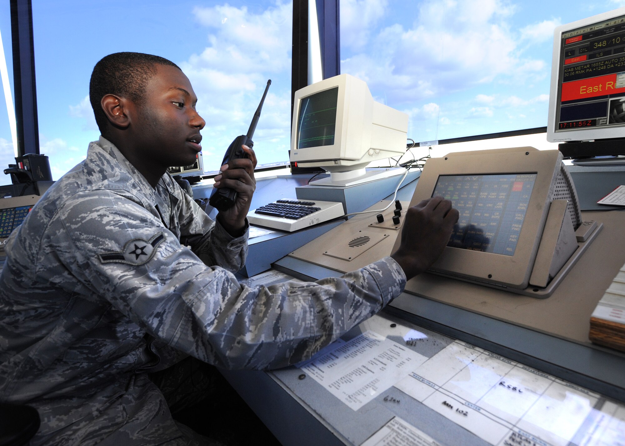 Airman Eric Emmanuel, 22nd Operations Support Squadron air traffic control journeyman, uses the Enhanced Terminal Voice System to grant a flightline driver permission to cross the airfield Oct. 12, 2010, McConnell Air Force Base, Kan.  Air traffic controllers frequently use this equipment to communicate with personnel operating vehicles and aircraft entering and leaving the airfield.  (U.S. Air Force photo/Airman 1st Class Andrea Salazar)