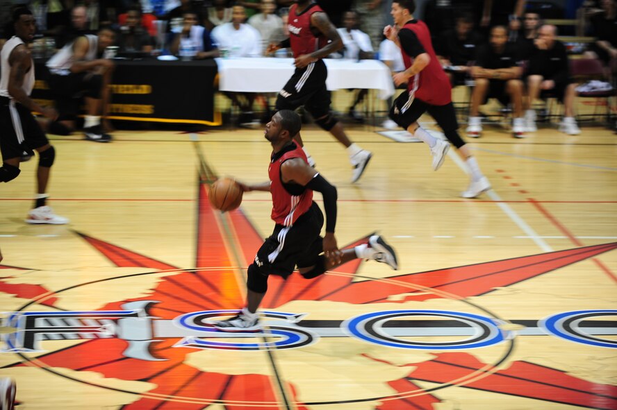 Dwyane Wade, Miami HEAT player, drives down the court during a scrimmage, at Hurlburt Field Fla., Oct. 1, 2010. The HEAT took time out from their training camp to display their skills in front of more than 500 Hurlburt and Eglin Air Force Base Airmen, DoD Civilians and dependents. (DoD Photo by Staff Sgt. Stephanie Jacobs/RELEASED)


