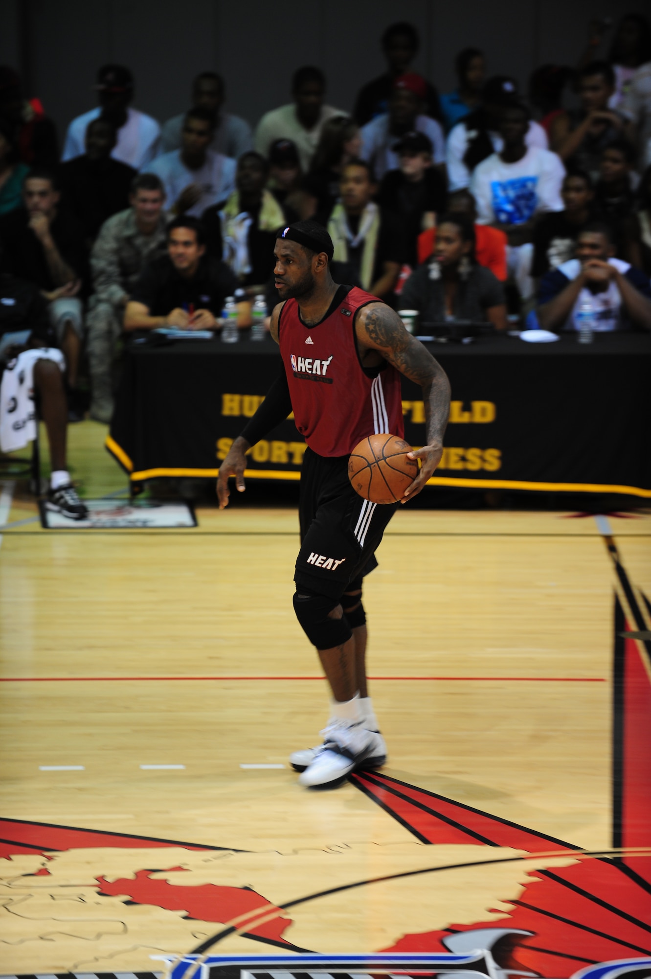 LeBron James, a Miami HEAT player, dribbles a ball down the court during a scrimmage at the Aderholt Fitness Center, Hurlburt Field Fla., Oct. 1, 2010. The HEAT took time out from their training camp to display their skills in front of more than 500 Hurlburt and Eglin Air Force Base Airmen, DoD Civilians and dependents. (DoD Photo by Staff Sgt. Stephanie Jacobs/RELEASED)

