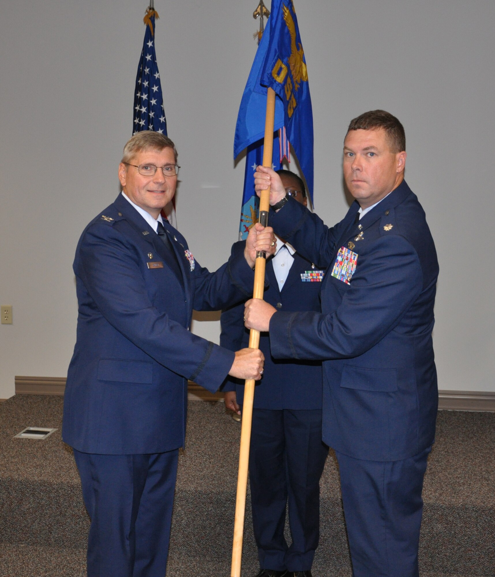 WRIGHT-PATTERSON AIR FORCE BASE, Ohio – Col. Roger Gallet, 445th Operations Group commander, passes the guidon to Lt. Col. Richard Webster, on the right, during a change of command ceremony Sept. 12. (U.S. Air Force photo/Senior Airman Mikhail Berlin)