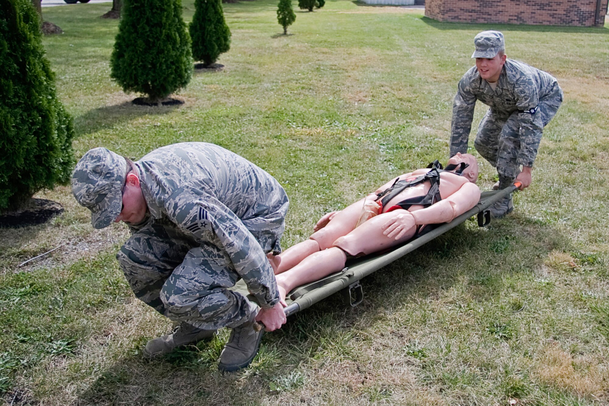 GRISSOM AIR RESERVE BASE, Ind. -- Senior Airman Matthew Stone, left, and newly promoted Airman Dustin Reich practice using a litter during a search and recovery exercise during the October unit training assembly. Both Airmen Stone and Reich are services specialists with the 434th Services Flight. Services Airman can be a part of special SAR teams, which are responsible for recovering personal effects or remains after a fatal event. (U.S. Air Force photo/Tech. Sgt. Mark R. W. Orders-Woempner)