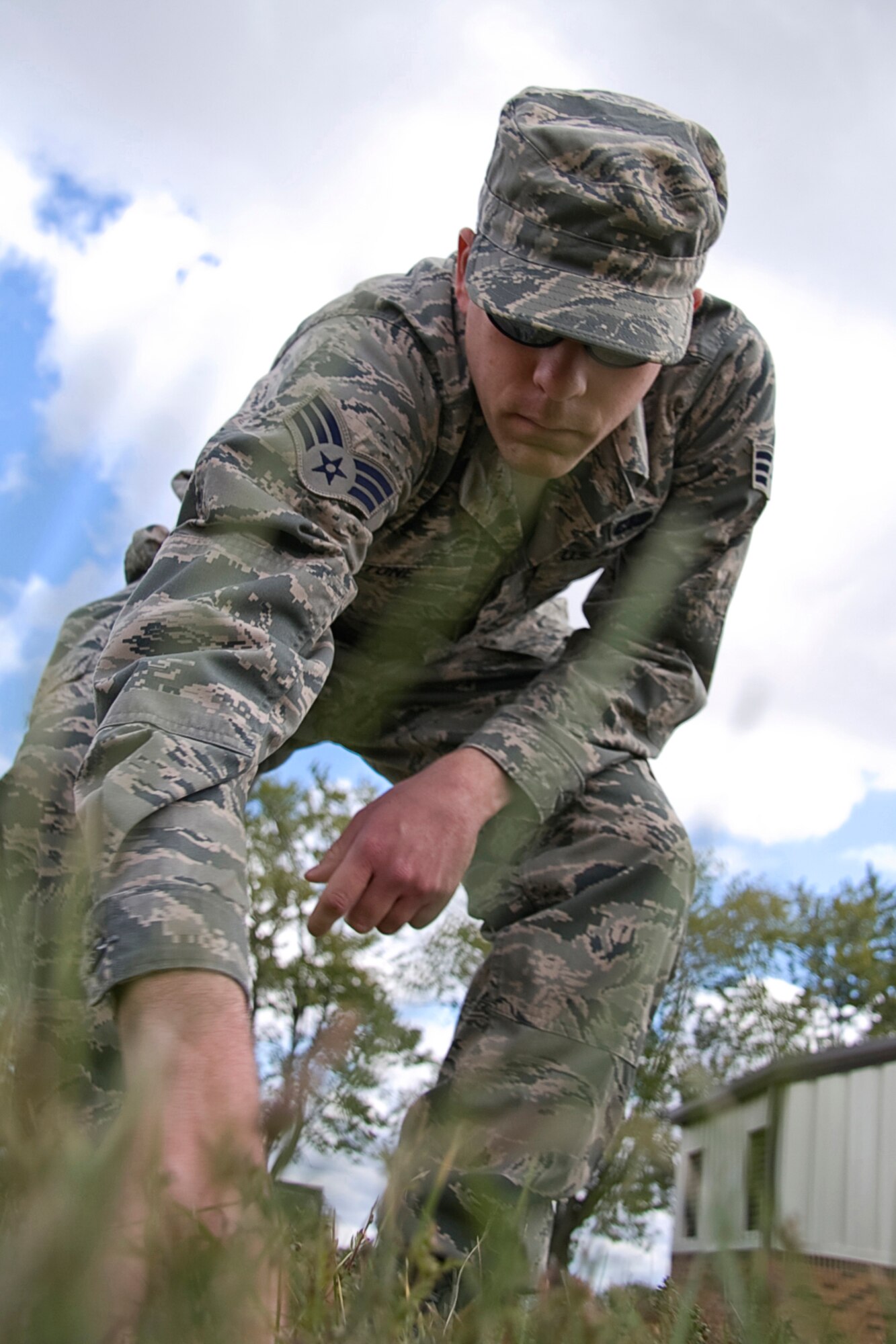 GRISSOM AIR RESERVE BASE, Ind. -- Senior Airman Matthew Stone searches through some thick grass behind the Civil Engineer Complex here as he and other members of the 434th Services Flight participate in a search and recovery exercise during the October unit training assembly. Services Airman can be a part of special SAR teams, which are responsible for recovering personal effects or remains after a fatal event. Airman Stone is a services specialist with the 434th SVF. (U.S. Air Force photo/Tech. Sgt. Mark R. W. Orders-Woempner)