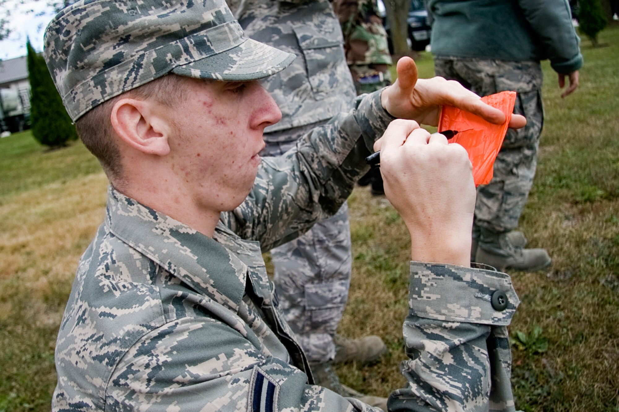 GRISSOM AIR RESERVE BASE, Ind. -- Airman 1st Class Donald R. Freed, Jr., marks a flag during a search and recovery exercise during the October unit training assembly. Airman Freed is a services specialist with the 434th Services Flight. Services Airman can be a part of special SAR teams, which are responsible for recovering personal affects or remains after a fatal event. (U.S. Air Force photo/Tech. Sgt. Mark R. W. Orders-Woempner)
