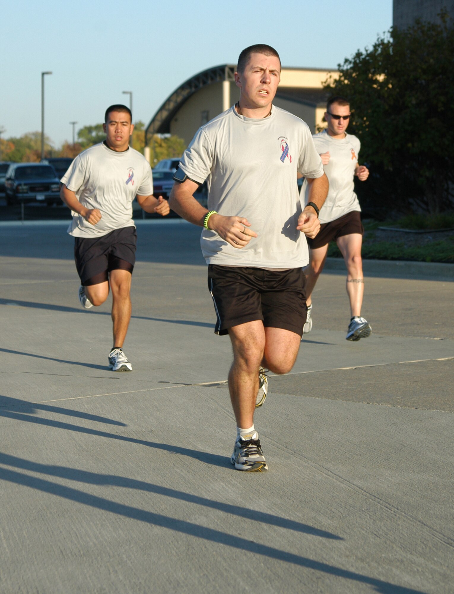 OFFUTT AIR FORCE BASE, Neb. - Airman 1st Class David J. Smith (front), a fitness specialist with the 55th Force Support Squadron, Airman 1st Class Wilson Delos Trino (left), a 55th FSS force management operations technician and Master Sgt. Johnathan M. Ward (right), personal reliability program monitor for the 55th Security Forces Squadron, begin a 9-mile run here Oct. 8. Sergeant Ward, along with Airmen Smith and Delos Trino are all members of the 55th FSS Marathon Running Team currently training to run the Rock 'n' Roll San Antonio Marathon on Nov. 14. U.S. Air Force photo by Staff Sgt. James M. Hodgman                      