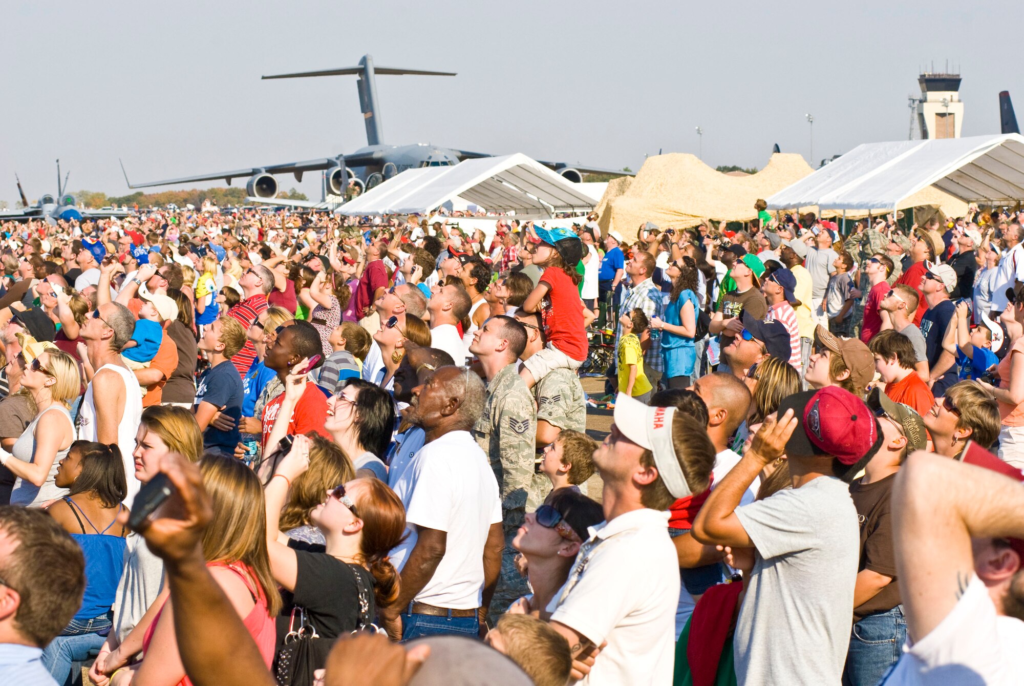 Audience members watch as demonstration teams soar over Little Rock Air Force Base, Ark., during the Thunder Over the Rock air show Oct. 10. Approximately 225,000 people came out for the two-day event, featuring 18 performances each day. (U.S. Air Force photo by Staff Sgt. Nestor Cruz)