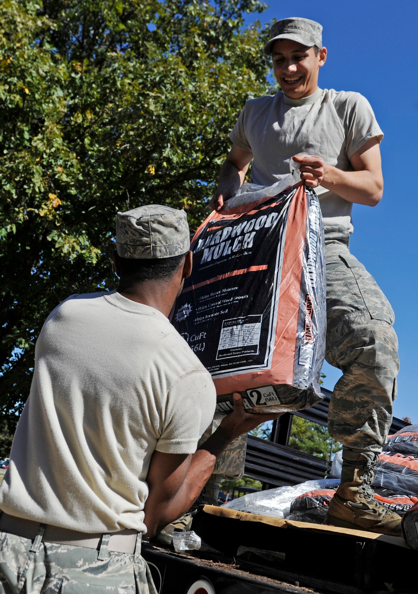 Staff Sgt. Gilberto Montoya, 375th Air Mobility Wing Chapel, unloads bags of mulch as a part of Scott PRIDE Oct. 8. Scott PRIDE is a 375th AMW led program that focuses on improving the already outstanding appearance of the base by fostering ownership through base-wide participation.  The program provides standards and guidelines for commanders, supervisors, and Team Scott servicemembers to achieve excellence in base appearance year-round. (U.S. Air Force photo/ Staff Sgt. Ryan Crane)