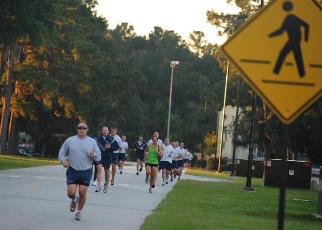 Member of Joint Base Charleston pace themselves as they near the three-quarter mile mark of the Commander's Fitness Challenge run Oct. 8, 2010, on Joint Base Charleston, S.C. More than 250 Airmen from various units came out to participate in the monthly challenge. The monthly event is open to all members of JB CHS. (U.S. Air Force photo/Senior Airman Timothy Taylor)