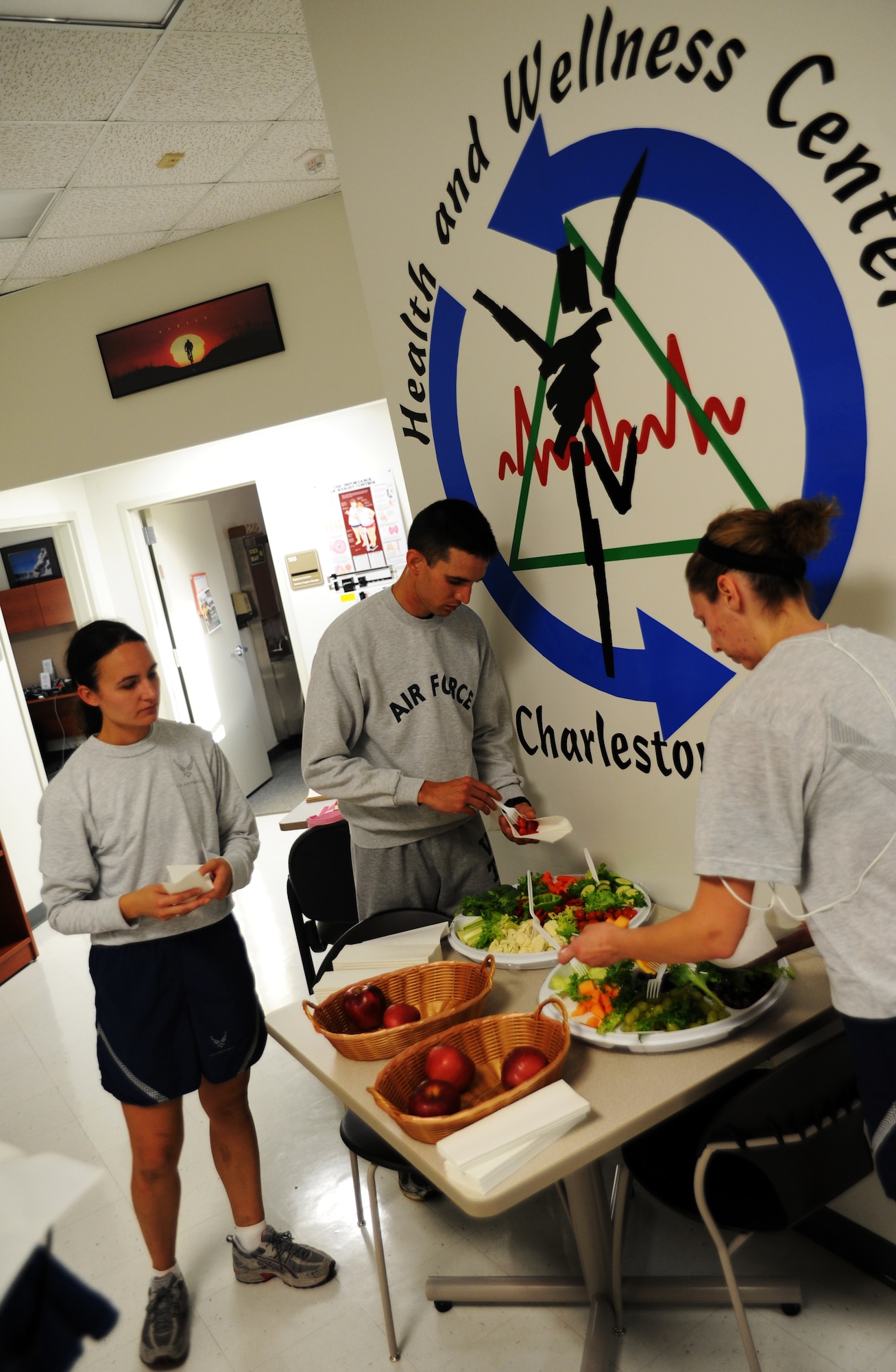 Airmen sample healthy snacks provided by the Health and Wellness Center after the Commanders Fitness Challenge run Oct. 8, 2010, on Joint Base Charleston, S.C. The HAWC offers many services to assist members of JB CHS in leading active and healthy lives. Some services offered include nutrition counseling, tobacco cessation classes, blood pressure screening and jogging strollers for use. The HAWC's hours of operation are from 7:30 a.m to 4:30 p.m. Monday through Friday. (U.S. Air Force photo/Senior Airman Timothy Taylor)