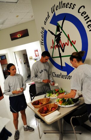 Airmen sample healthy snacks provided by the Health and Wellness Center after the Commanders Fitness Challenge run Oct. 8, 2010, on Joint Base Charleston, S.C. The HAWC offers many services to assist members of JB CHS in leading active and healthy lives. Some services offered include nutrition counseling, tobacco cessation classes, blood pressure screening and jogging strollers for use. The HAWC's hours of operation are from 7:30 a.m to 4:30 p.m. Monday through Friday. (U.S. Air Force photo/Senior Airman Timothy Taylor)