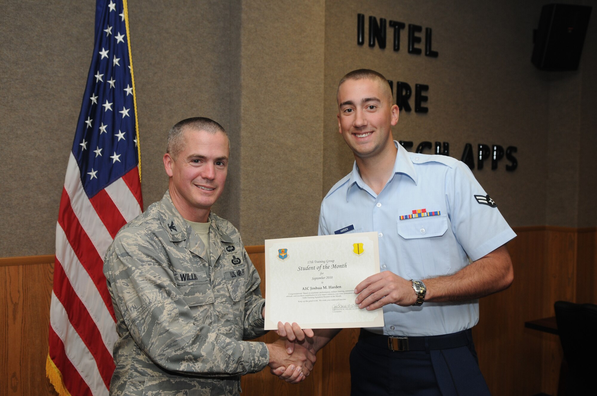 Airman 1st Class Joshua Harden, 316th Training Squadron, accepts his September Student of the Month award from Col. J.D. Willis, 17th Training Group commander. (U.S. Air Force photo/Airman 1st Class Clayton Lenhardt)